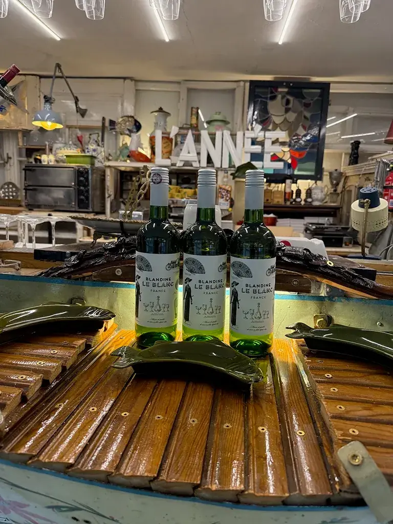 Drei Flaschen Weißwein auf dem Holzdeck des Boot-Tresens